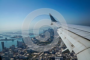 Passenger plane flying over Miami descends for landing at Miami International Airport