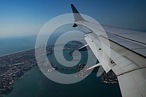 Passenger plane flying over Miami descends for landing at Miami International Airport