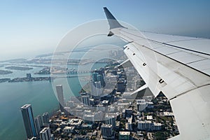 Passenger plane flying over Miami descends for landing at Miami International Airport