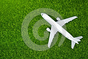 Passenger plane on the grass. Green air transportation of passengers and cargo.