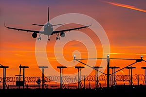 Passenger plane landing during sunset