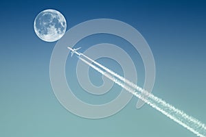 Passenger plane passes near the moon photo