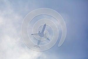 Passenger plane passing through the clouds