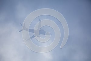 Passenger plane passing through the clouds