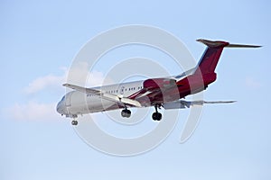 Passenger plane sits isolated on a blue sky background.