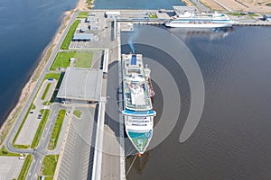 Passenger port with two cruise liners, preparing for departure on a trip