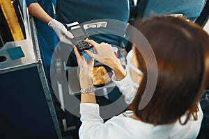 Passenger putting her banking card password into terminal