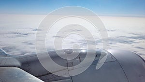 A passenger`s view looking out the window of an airplane flying though the clouds. Shot at 4k