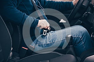 Passenger senior man fastening seat belt in the car, transport and safety concept