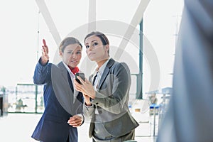 Passenger service agent assisting and giving directions with businesswoman in airport photo