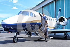 Passenger standing in door of business jet