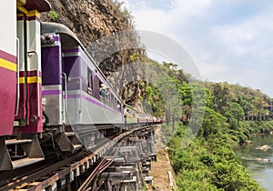Passenger thai train moving on death of railway world war II at tham krasae railway station river kwai