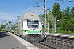 Passenger train arriveson on the railway station on a sunny June day. Hameenlinna, Finland