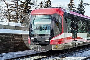 Passenger Train Arriving into a Station on a Sunny Winter Day