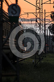 Passenger train going towards Jurmala during sunset