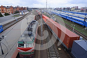 Passenger train parked at the train station top view. Locomotive and freight train.