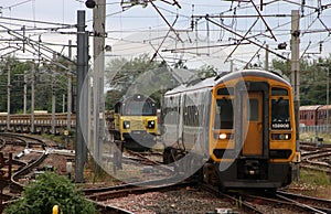 Passenger train passing freight train at Carnforth