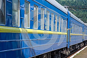Passenger train is preparing to depart from the railway station, located in the mountains