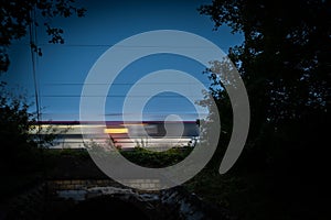 Passenger train on railroad tracks at night