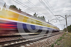 Passenger train on railroad tracks in speed motion