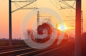 Passenger train on railway at sunset