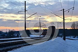 Passenger train on railway at sunset