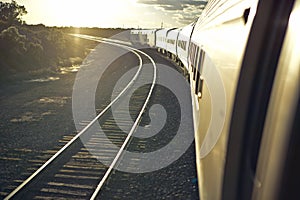 Passenger train traveling into the Arizona sunset