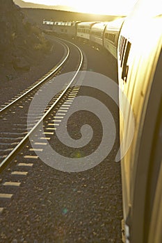 Passenger train traveling into the Arizona sunset