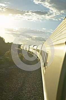 Passenger train traveling into the Arizona sunset