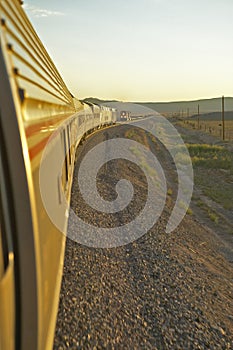 Passenger train traveling into the Arizona sunset