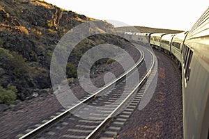 Passenger train traveling into the Arizona sunset