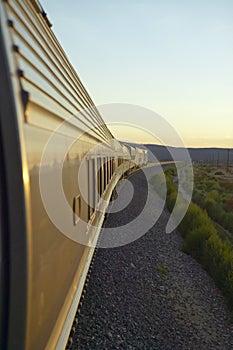 Passenger train traveling into the Arizona sunset