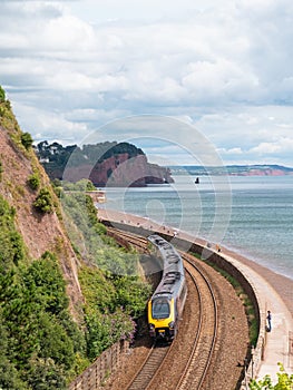 Passenger train travelling along the spectacular route towards Dawlish in south Devon UK