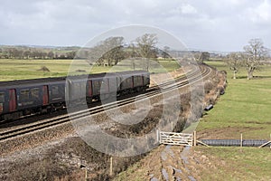 Passenger train travels south of Exeter in Devon UK