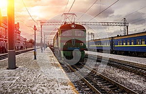 Passenger train went from the platform in the sun