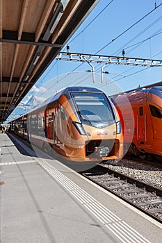 Passenger trains type Stadler Flirt of SÃÂ¼dostbahn at railway station in Arth-Goldau, Switzerland