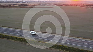 Passenger van driving fast on intercity road at sunset. Highway traffic in evening