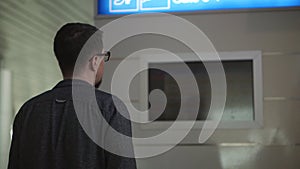 Passenger is viewing information board in airport