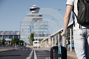 Passenger waiting at bus station in front of airport