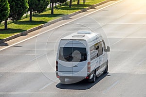 Passenger white minibus accelerating ride on highway