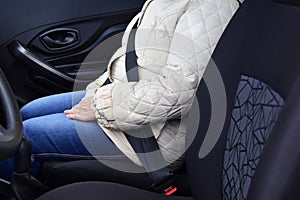 Passenger woman fastening seat belt in the car, safety concept. color toned image