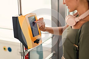 Passenger Woman Using Ticket Machine In Modern Tram Indoor, Cropped