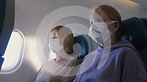 Passengers of the aircraft in protective masks during the flight. Protective measures during the covid-19 pandemic