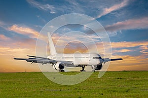 Passengers airplane landing to airport runway in beautiful sunset light, mileage and braking speed reduction