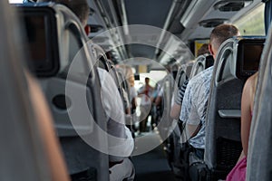 The passengers in the bus during the trip with tourists and guided tour.