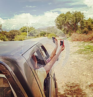 Passengers of the car far from civilization are looking for a mobile phone network signal. No connection