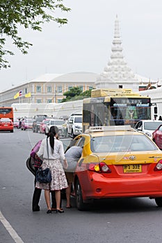 Passengers gettng in a taxi