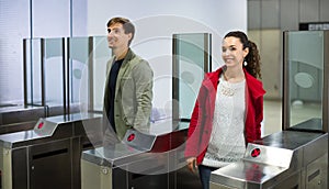 Passengers passing the turnstile