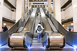 Passengers riding escalator in train station Bucharest, Romania