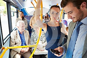 Passengers Standing On Busy Commuter Bus